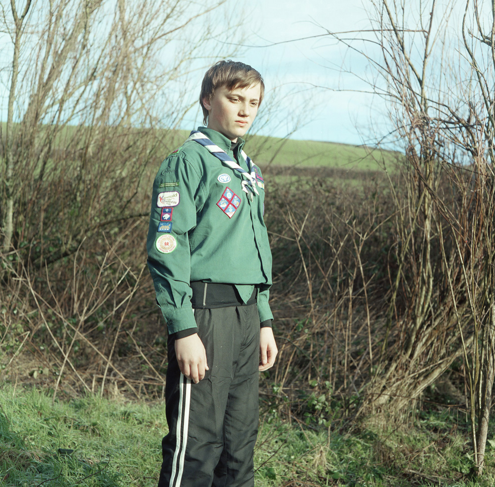 A 13-year-old boy stands proud in his scout uniform at a small farm near Laugharne in Carmarthenshire, on the edge of the Landsker line. The Landsker line is an invisible but definite line that has been present for nearly a thousand years and divides the South West corner of Wales from the rest of the country.