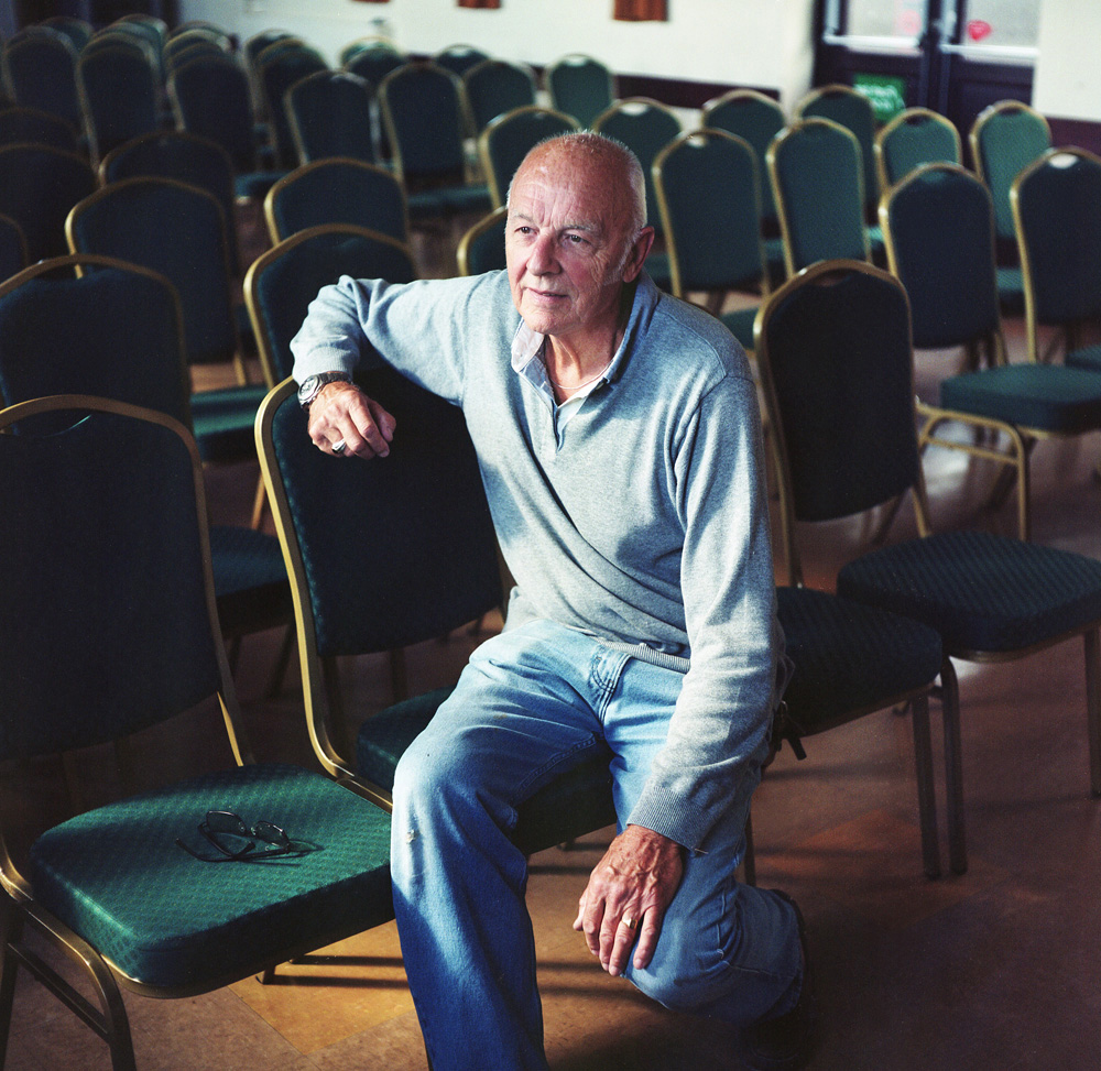 Clive Law moved to Pembrokeshire 20 years ago from Reading near London. He was attracted to the natural beauty of the rural landscape. Here he sits at his local village hall in Penally.